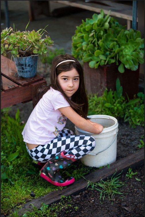 Child in garden with plants