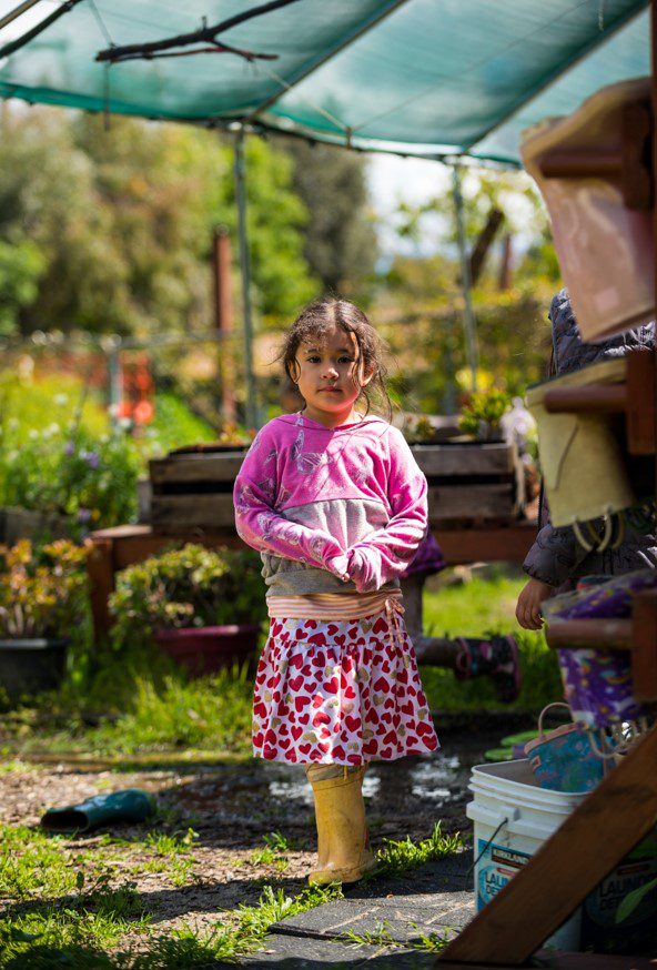 Child standing in a garden