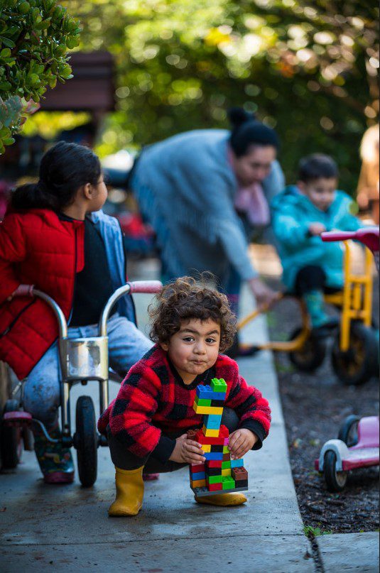 Child playing with colorful blocks outdoors