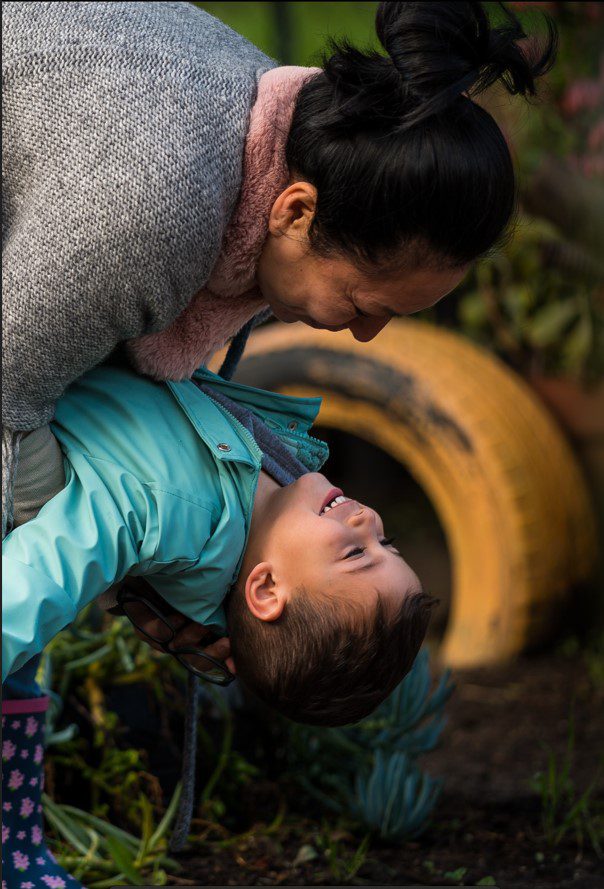 Mother playing with child outside